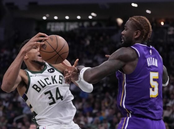 Laker Deandre Ayton comete falta na estrela do Bucks, Giannis Antetokounmpo, no sábado em Milwaukee.